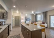 Thumbnail 6 of 34 - furnished model living room and kitchen