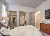 Thumbnail 9 of 34 - furnished model bedroom with walk-in closet and attached bathroom