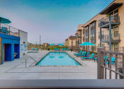 Thumbnail 15 of 34 - our apartments have a pool and a building with chairs and umbrellas