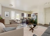 Thumbnail 5 of 32 - a living room and kitchen with a couch and a table