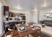 Thumbnail 3 of 32 - a living room with a dining room table and a kitchen
