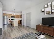 Thumbnail 1 of 32 - a living room with a tv and a kitchen with stainless steel appliances