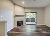 Thumbnail 41 of 45 - A room with a fireplace and sliding glass doors.
