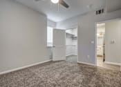 Thumbnail 36 of 45 - A spacious room with a carpeted floor and a ceiling fan.