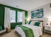 Thumbnail 7 of 38 - a bedroom with green walls and a bed with a large window