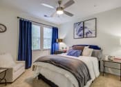 Thumbnail 2 of 38 - a bedroom with a bed and a ceiling fan
