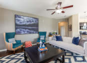 Thumbnail 4 of 31 - a living room with a couch and a coffee table