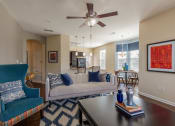 Thumbnail 17 of 31 - a living room with a ceiling fan and a couch