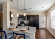 Thumbnail 3 of 31 - a kitchen with black appliances and a granite counter top