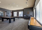 Thumbnail 16 of 31 - a game room with a pool table and a shuffleboard