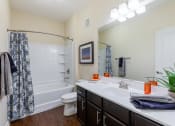 Thumbnail 30 of 31 - a bathroom with a sink and a shower and a toilet