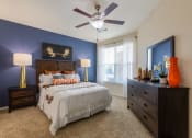 Thumbnail 7 of 31 - a bedroom with a bed and a ceiling fan