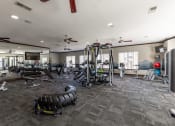 Thumbnail 24 of 31 - spacious gym with cardio machines and weights at the enclave at woodbridge apartments