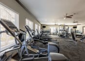 Thumbnail 29 of 31 - the fitness center has cardio equipment and treadmills in the gym