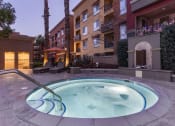 Thumbnail 13 of 31 - Nighttime shot of spa with buildings in the background.