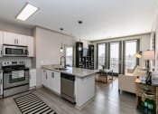 Thumbnail 2 of 33 - an open kitchen and living room with a view of the city at Westmount at Ashwood, Georgia, 30338
