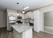 Thumbnail 15 of 33 - a kitchen with white cabinets and a granite counter top at Westmount at Ashwood, Atlanta, Georgia