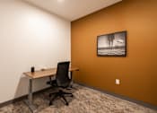 Thumbnail 42 of 68 - A black office chair is in front of a desk with a framed picture of a woman on the wall.