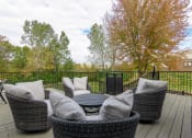 Thumbnail 20 of 27 - a patio with chairs and a table on a deck