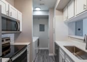 Thumbnail 4 of 27 - a renovated kitchen with white cabinets and stainless steel appliances