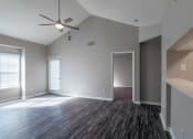 Thumbnail 1 of 27 - an empty living room with a ceiling fan