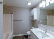 Thumbnail 6 of 27 - a bathroom with a sink toilet and shower and a mirror