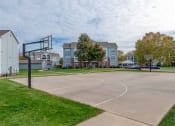 Thumbnail 22 of 27 - a basketball court in front of a row of houses