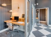 Thumbnail 6 of 29 - a desk with a computer in a room with a door