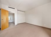 Thumbnail 15 of 27 - an empty living room with a door to a bathroom