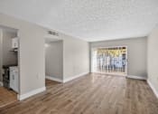 Thumbnail 12 of 31 - A room with wooden floors and white walls.