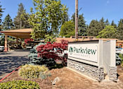Thumbnail 18 of 21 - The image shows the entrance to Parkview Apartments with a sign and a landscaped area in front.