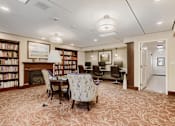 Thumbnail 7 of 15 - A room with a carpeted floor and a fireplace.