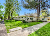Thumbnail 15 of 15 - A house with a white fence and a green lawn.