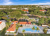 Thumbnail 2 of 31 - A large clubhouse with a pool in the backyard.