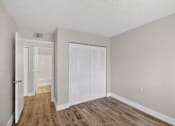 Thumbnail 21 of 31 - A room with a white door and a white closet.