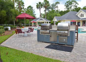 Thumbnail 2 of 14 - Exterior Pool Deck BBQ Grills at Magnolia Place Apartment, Gainesville