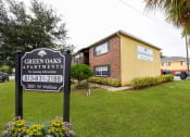 Thumbnail 2 of 28 - Entrance Sign at Green Oaks Apartments, Florida