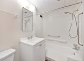 Thumbnail 6 of 27 - a white bathroom with a shower and a sink