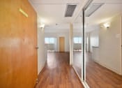 Thumbnail 4 of 27 - an empty hallway with wooden floors and a glass door