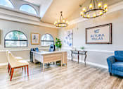 Thumbnail 3 of 14 - A room with a desk, chairs, and a framed sign that says "Altura Villas".