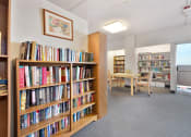 Thumbnail 22 of 27 - a room filled with bookshelves and a table with chairs