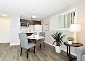 Thumbnail 4 of 21 - A dining room with a table set for two.