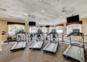 Thumbnail 12 of 22 - Fitness center with multiple treadmills and televisions at Borgata Condominiums Apartments, Las Vegas, Nevada