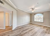 Thumbnail 21 of 22 - Spacious empty living area with wood style flooring at Borgata Condominiums Apartments, Las Vegas