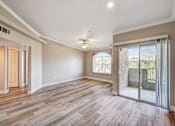 Thumbnail 17 of 22 - Open living room with sliding glass door at Borgata Condominiums Apartments, Nevada