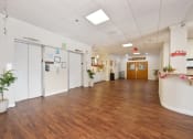Thumbnail 24 of 27 - a large room with a wood floor and white walls and doors