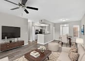 Thumbnail 8 of 20 - A modern living room with a flat screen TV, a coffee table, and a ceiling fan.