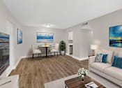 Thumbnail 11 of 31 - A living room with a white couch, a coffee table, and a painting on the wall.