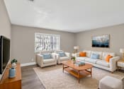 Thumbnail 5 of 15 - A living room with a white couch, a coffee table, and a television. at Willow Brooke Apartments, Apartments, Tampa, FL