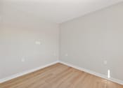 Thumbnail 18 of 25 - a bedroom with grey walls and a wooden floor at Azure Point at Encinitas, Encinitas California